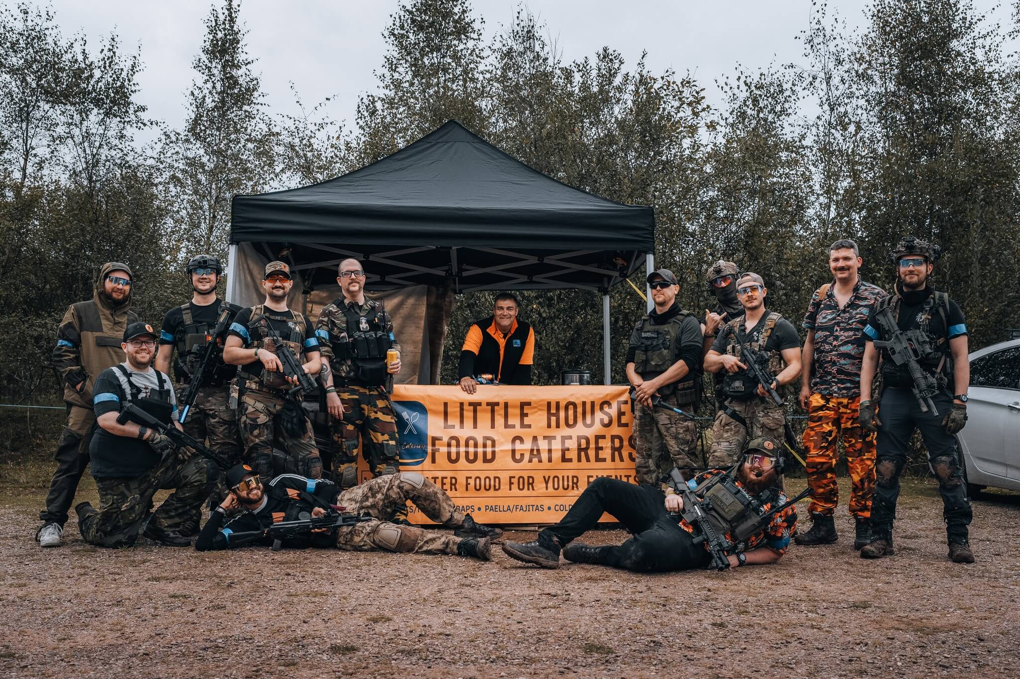 Nemesis Tactical and Tropic Thunder group photo with Little House Food Caterers banner